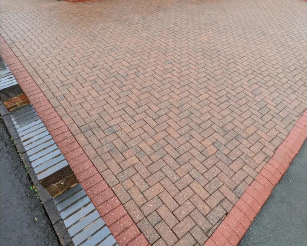 Block paving driveway after SmartGuard deep cleaning, looking brighter and restored.